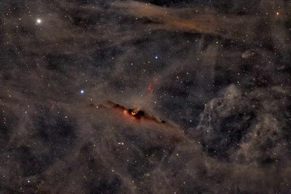 The Red Glow of the Cosmic Bat Nebula